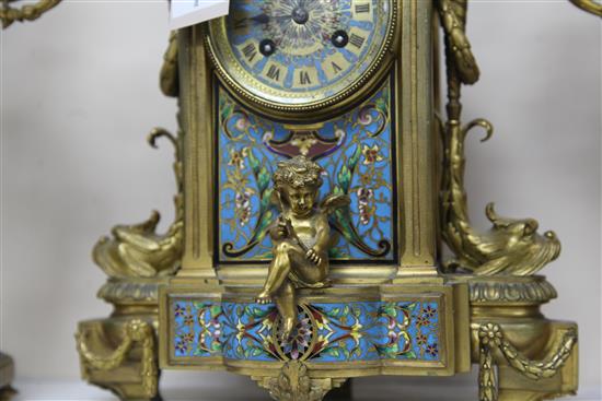 A third quarter of the 19th century French champlevé enamel and ormolu clock garniture, height clock 14in. candelabra 14.75in.